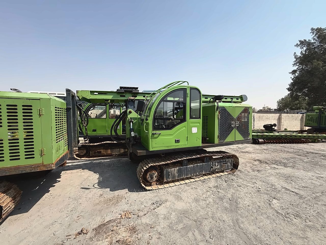 Crawler-mounted drilling rig in the yard, side view