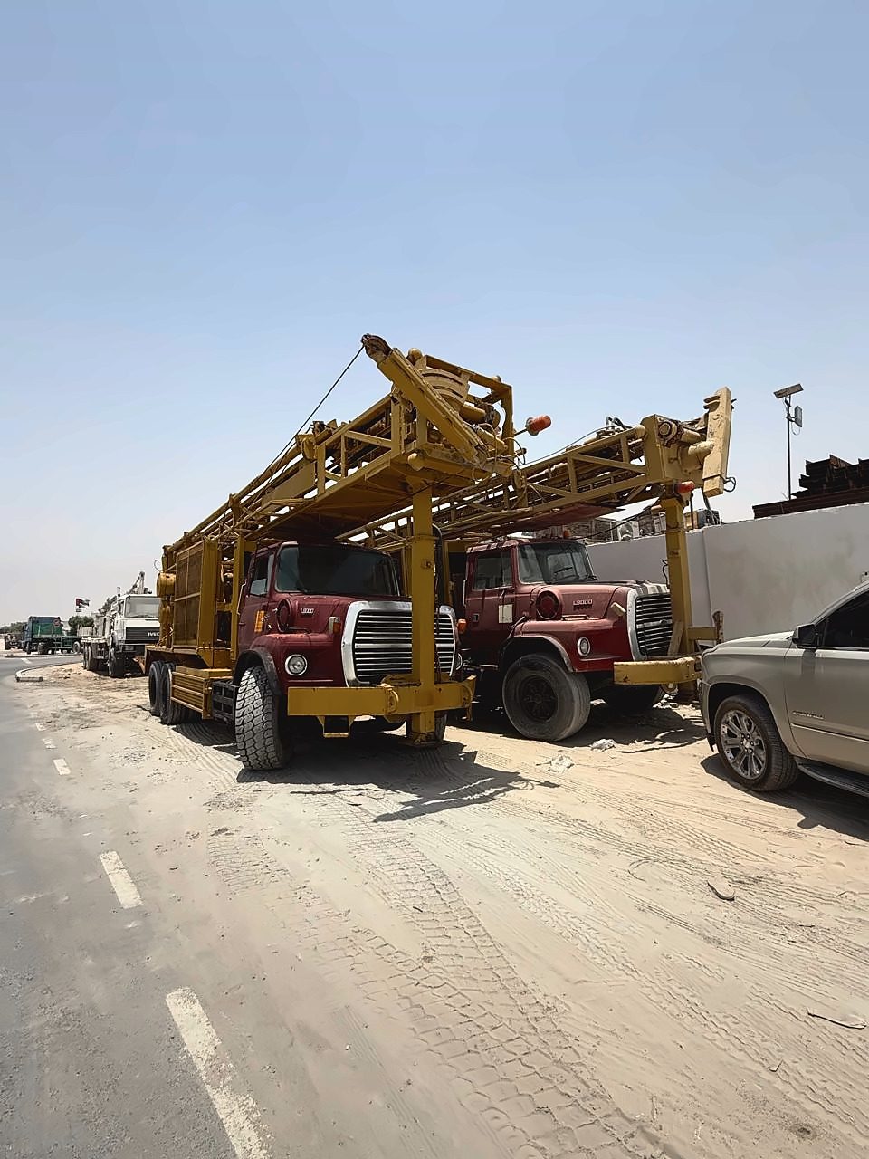 Two drilling rigs on Ford L8000 and L9000 trucks